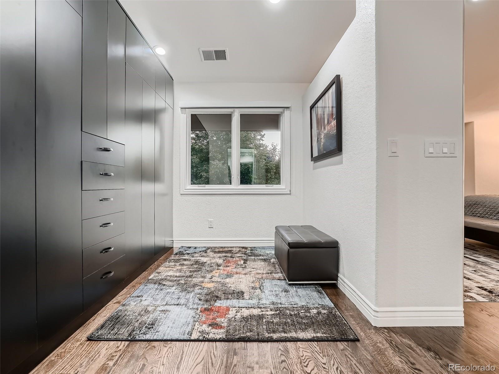 338 St Paul Street Denver, CO 80206 - Photo 28 of 40 a view of a hallway with front door and wooden floor