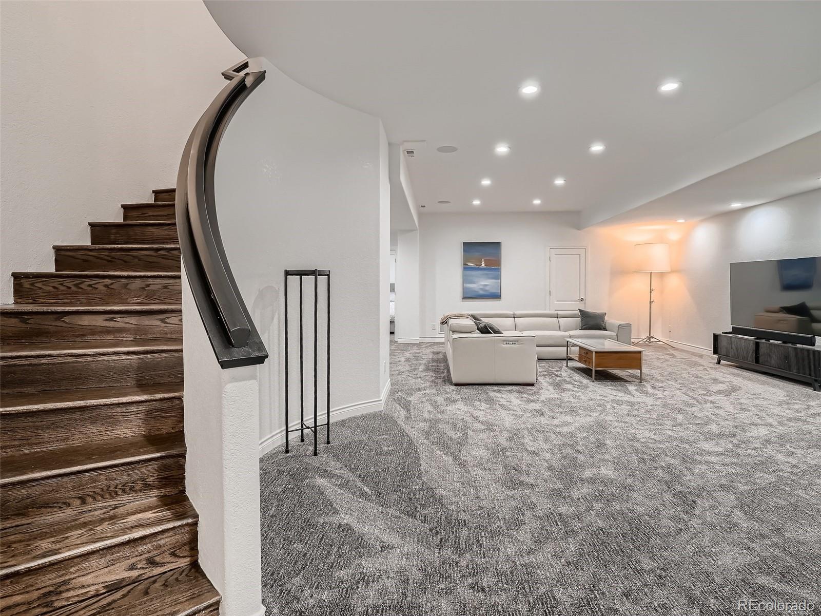 338 St Paul Street Denver, CO 80206 - Photo 33 of 40 a living room with furniture and a flat screen tv