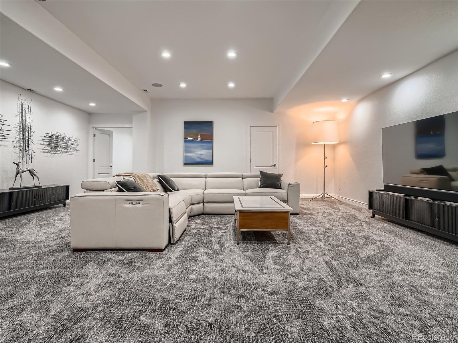 338 St Paul Street Denver, CO 80206 - Photo 35 of 40 a living room with furniture and a flat screen tv