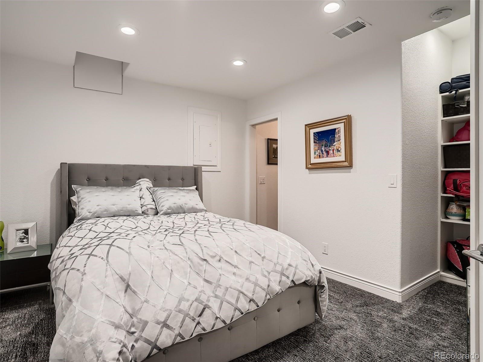 338 St Paul Street Denver, CO 80206 - Photo 38 of 40 a bedroom with a bed and painting on the wall