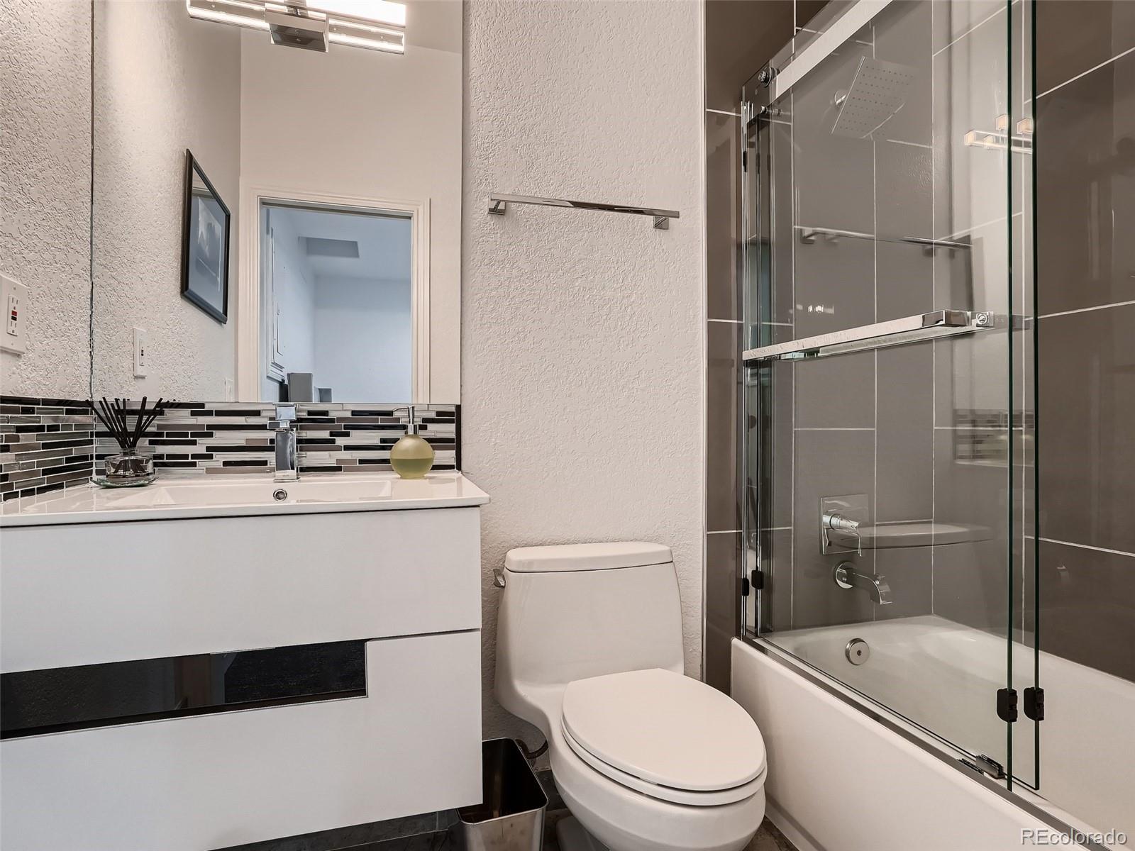 338 St Paul Street Denver, CO 80206 - Photo 39 of 40 a bathroom with a sink a toilet and shower