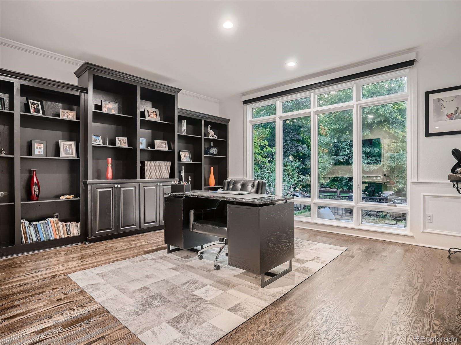338 St Paul Street Denver, CO 80206 - Photo 6 of 40 a view of a workspace with furniture and a window
