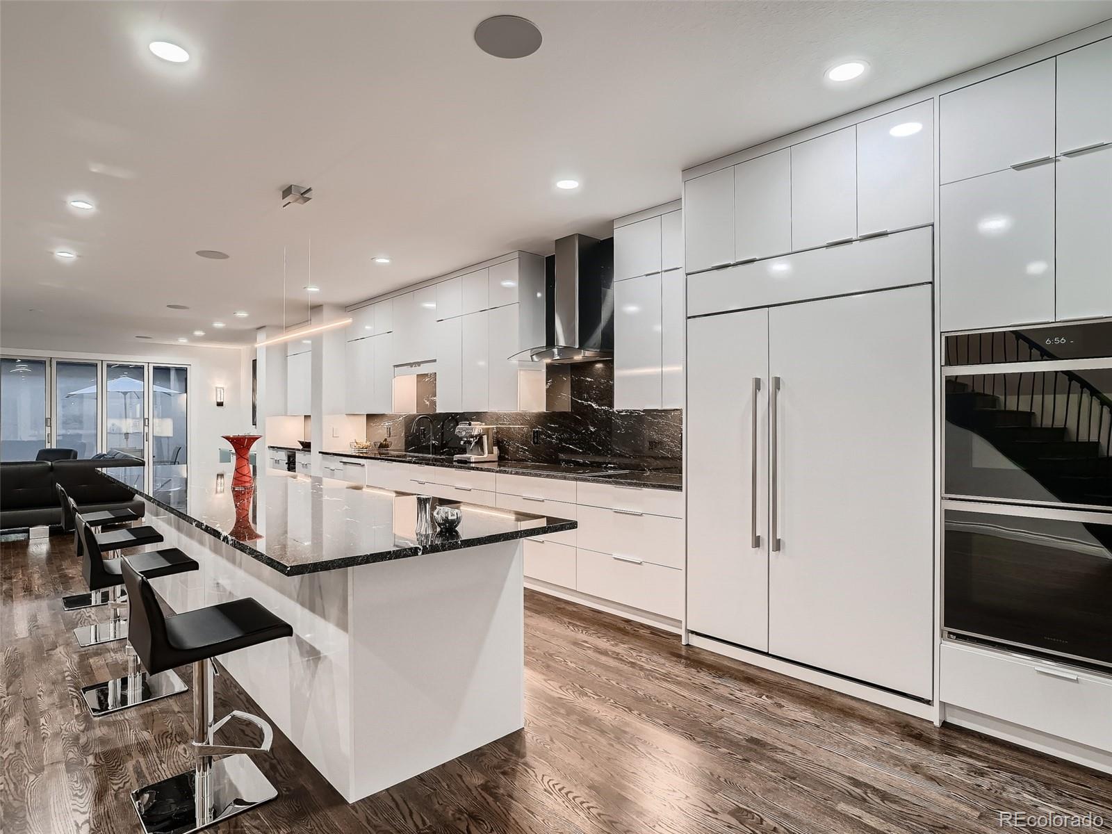 338 St Paul Street Denver, CO 80206 - Photo 8 of 40 a kitchen with kitchen island a counter top space appliances and cabinets