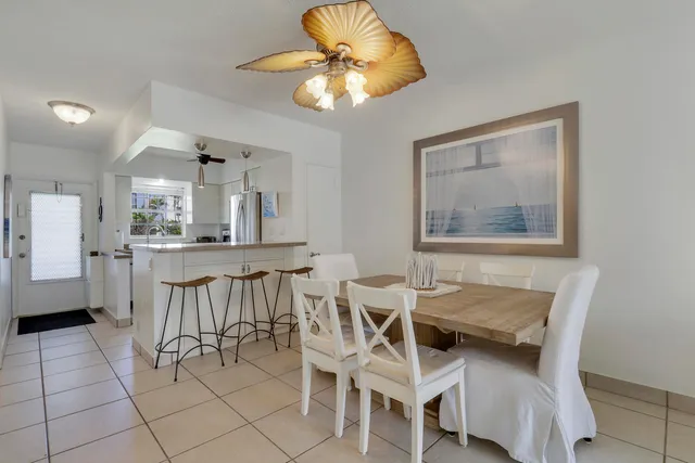 a dining room with furniture and chandelier