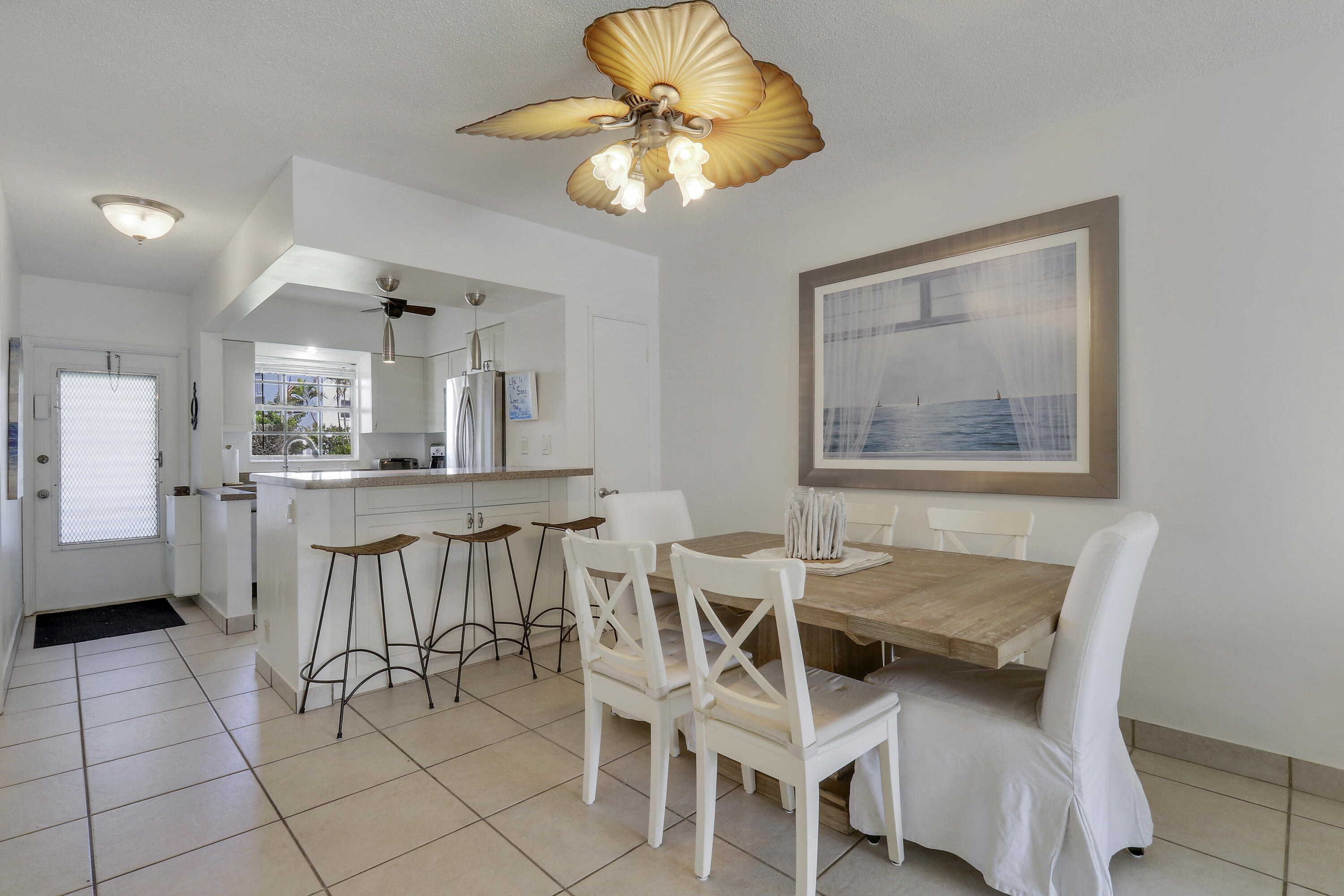 298 Southeast 6th Avenue, Unit 6 Pompano Beach, FL 33060 - Photo 26 of 36 a dining room with furniture and chandelier