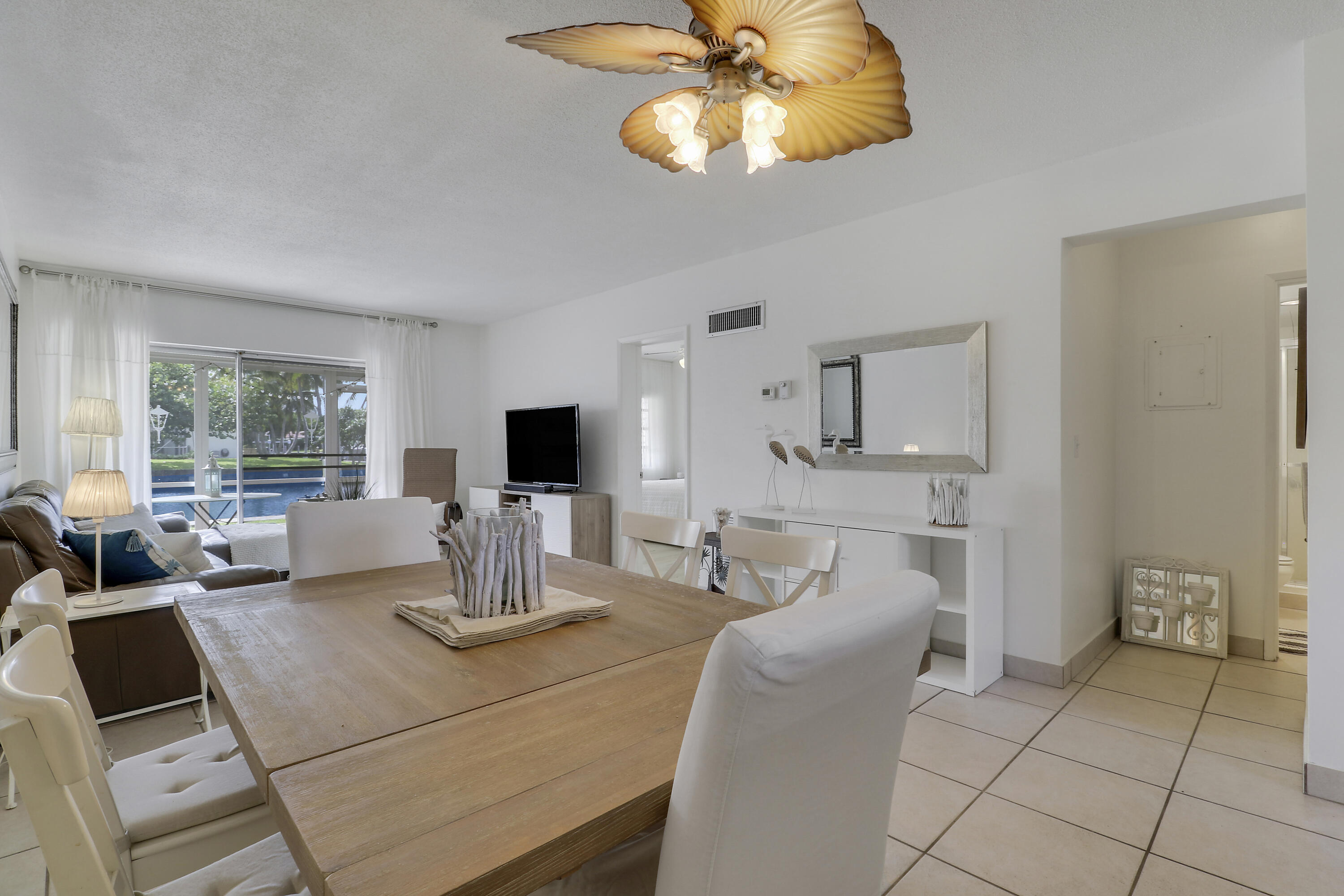 298 Southeast 6th Avenue, Unit 6 Pompano Beach, FL 33060 - Photo 29 of 36 a living room with furniture and a flat screen tv