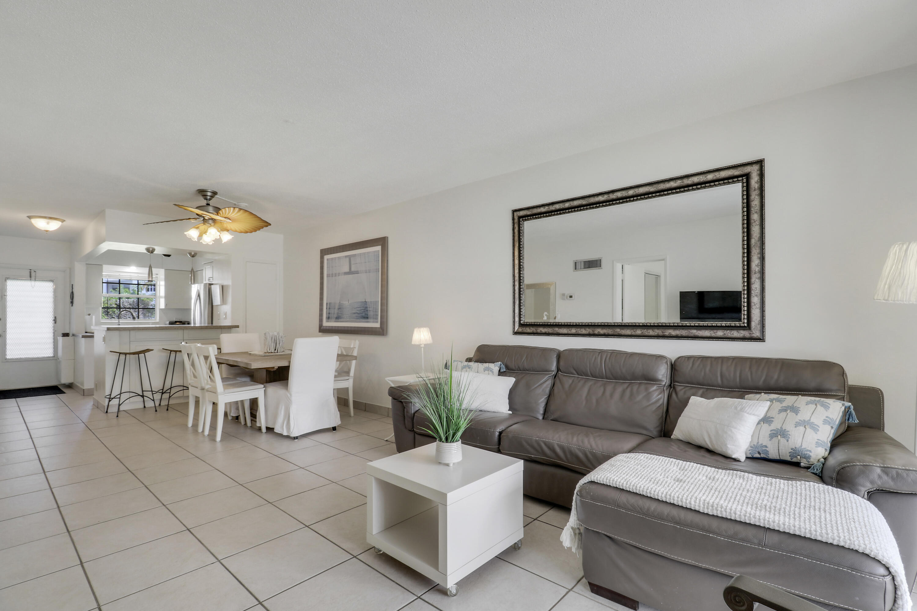 298 Southeast 6th Avenue, Unit 6 Pompano Beach, FL 33060 - Photo 30 of 36 a living room with furniture and a chandelier