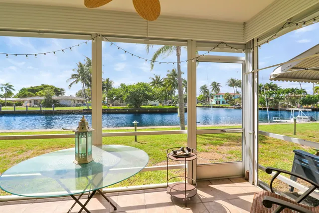 a view of a swimming pool with a table and chairs