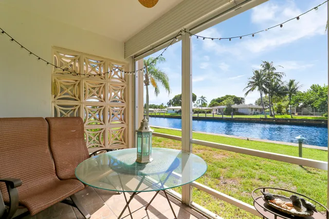 a room with furniture and a floor to ceiling window