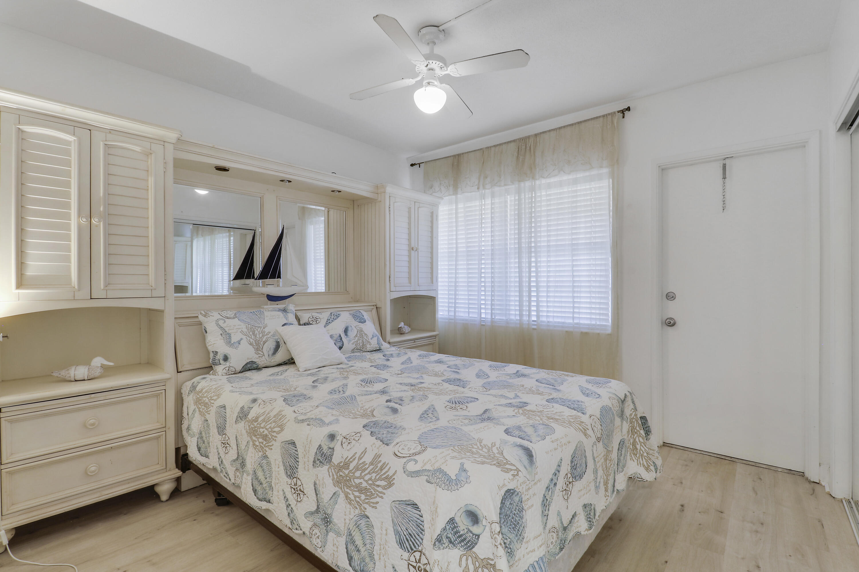 298 Southeast 6th Avenue, Unit 6 Pompano Beach, FL 33060 - Photo 8 of 36 a bedroom with a large bed and a chandelier fan