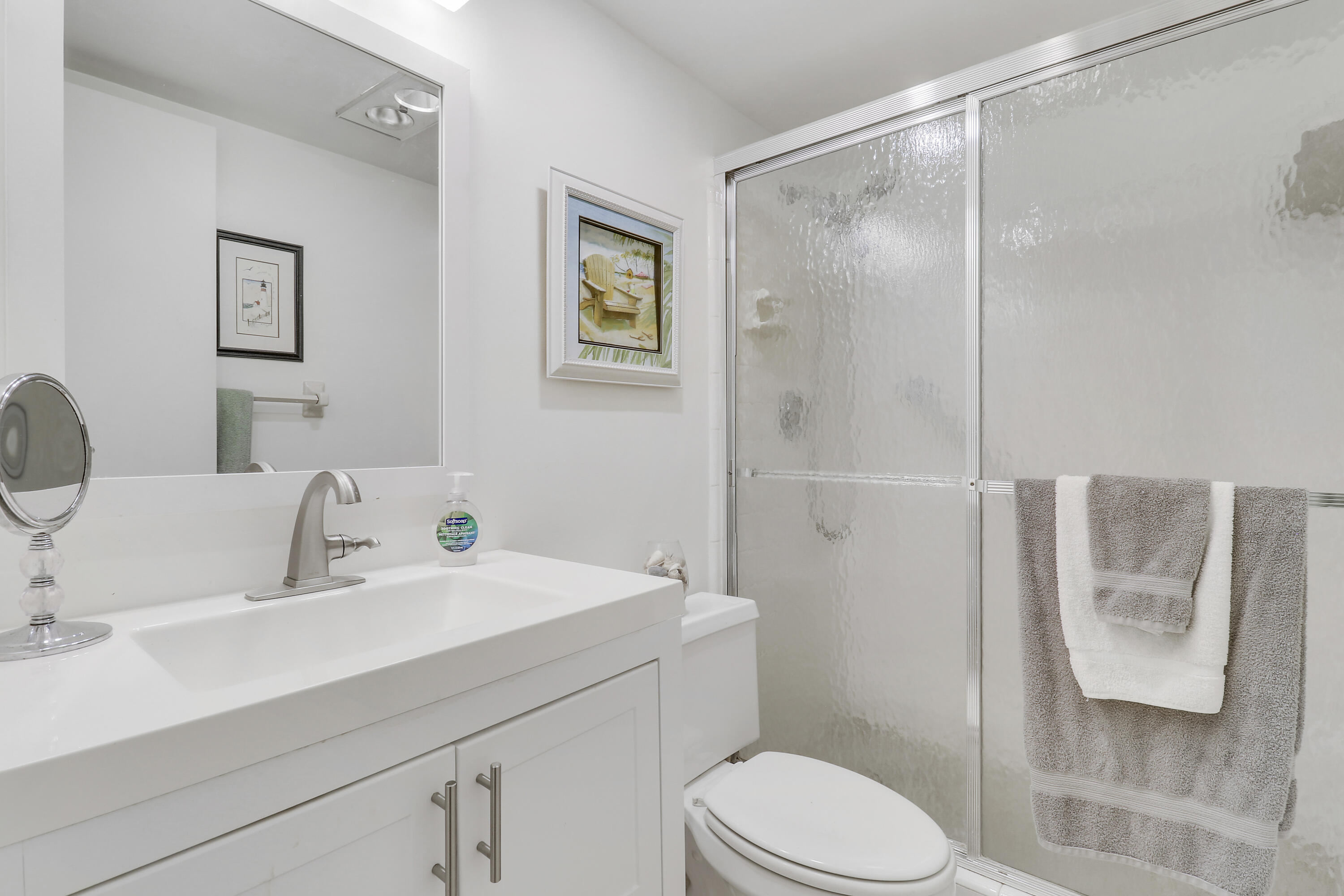 298 Southeast 6th Avenue, Unit 6 Pompano Beach, FL 33060 - Photo 9 of 36 a bathroom with a sink mirror vanity and toilet