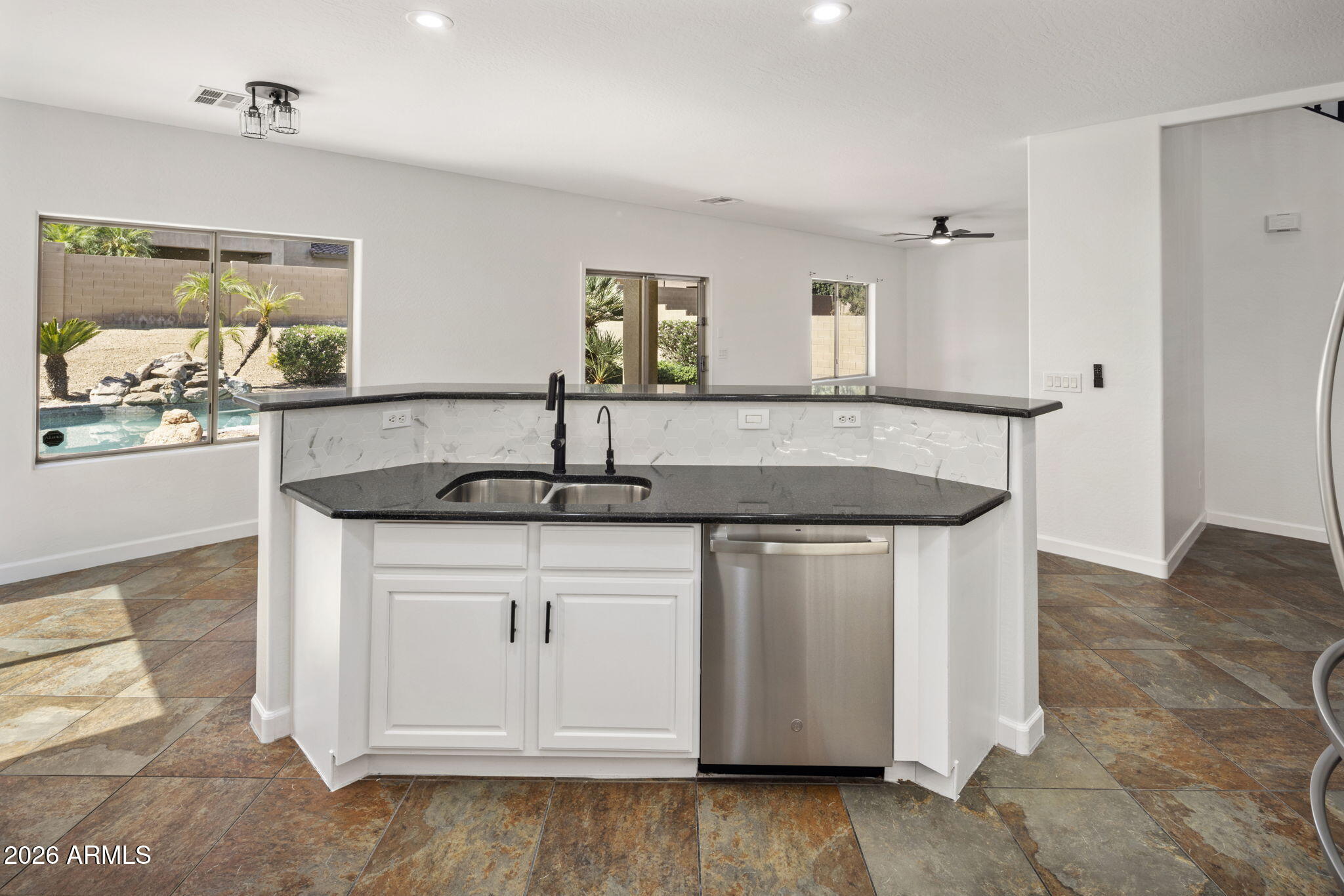 5121 West Beverly Road Laveen, AZ 85339 - Photo 20 of 32 a kitchen with stainless steel appliances granite countertop a sink and a granite counter tops with white cabinets