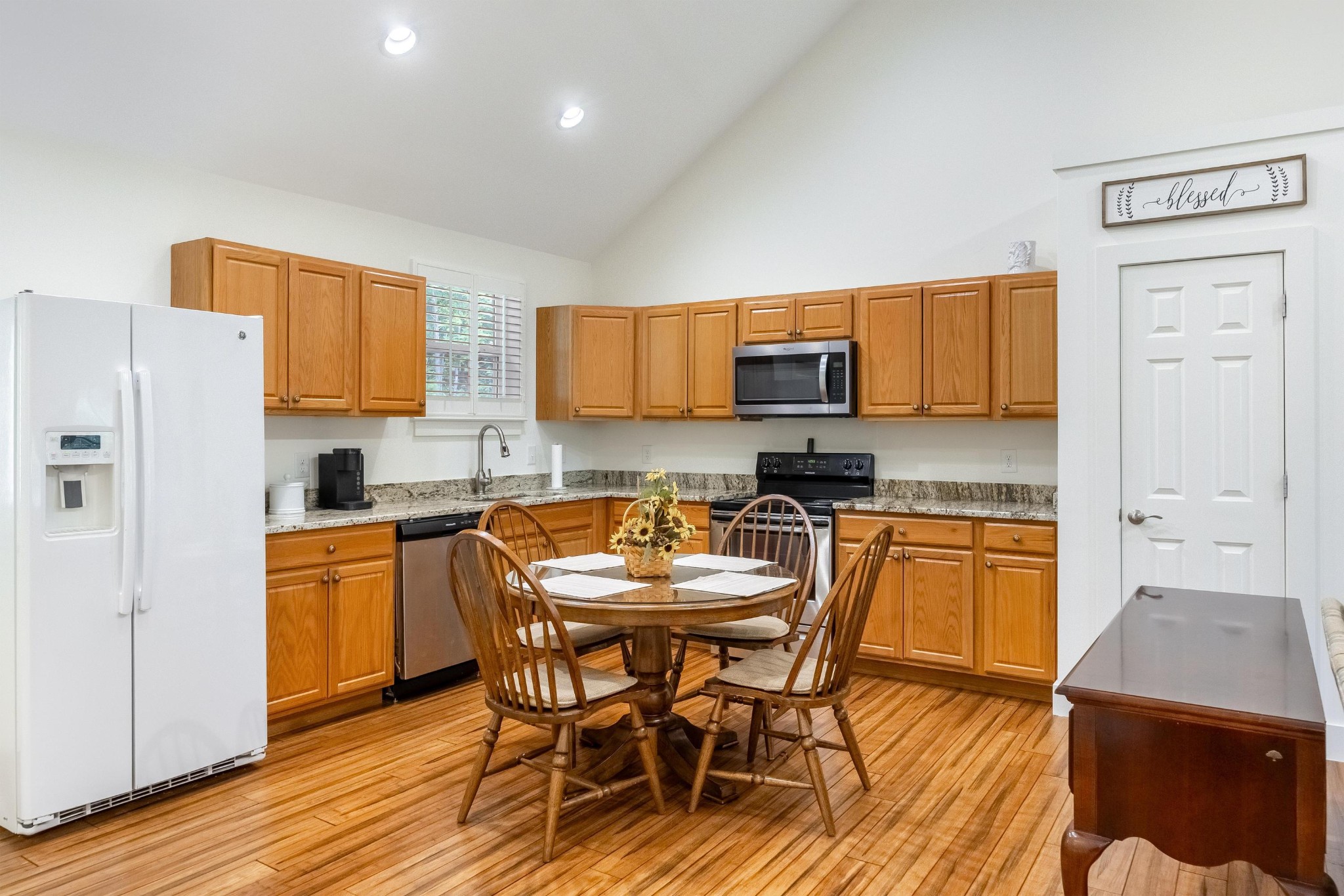 6435 Davis Hill Road Birchwood, TN 37308 - Photo 46 of 64 a kitchen with stainless steel appliances granite countertop a stove a sink a microwave a refrigerator a dining table and chairs with wooden floor
