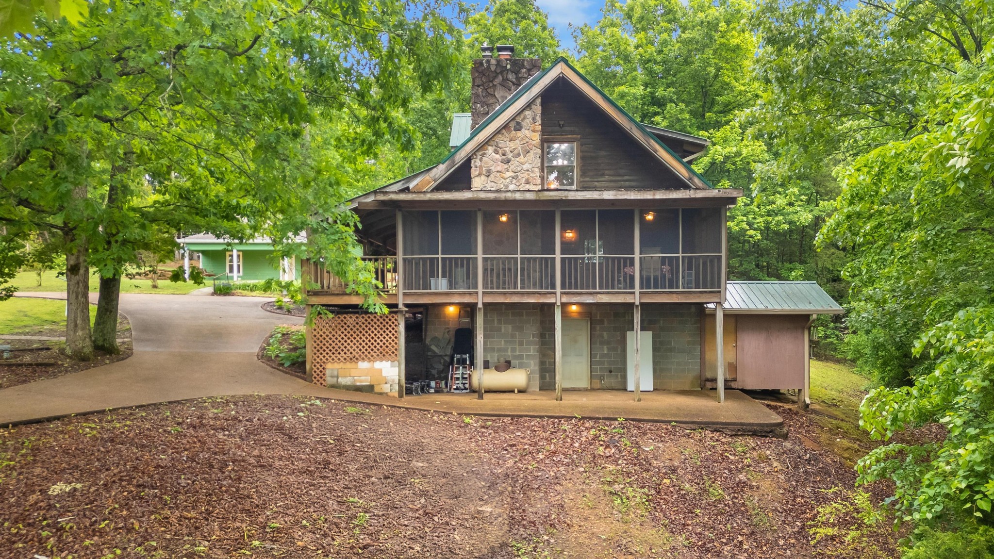 6435 Davis Hill Road Birchwood, TN 37308 - Photo 9 of 64 a view of a small house with a yard and large tree