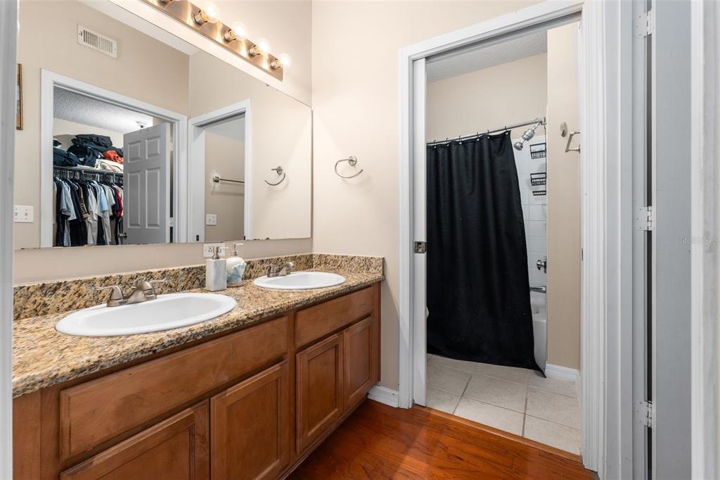 10000 Southwest 52nd Avenue, Unit 35 Gainesville, FL 32608 - Photo 17 of 36 a bathroom with a double vanity sink and a mirror