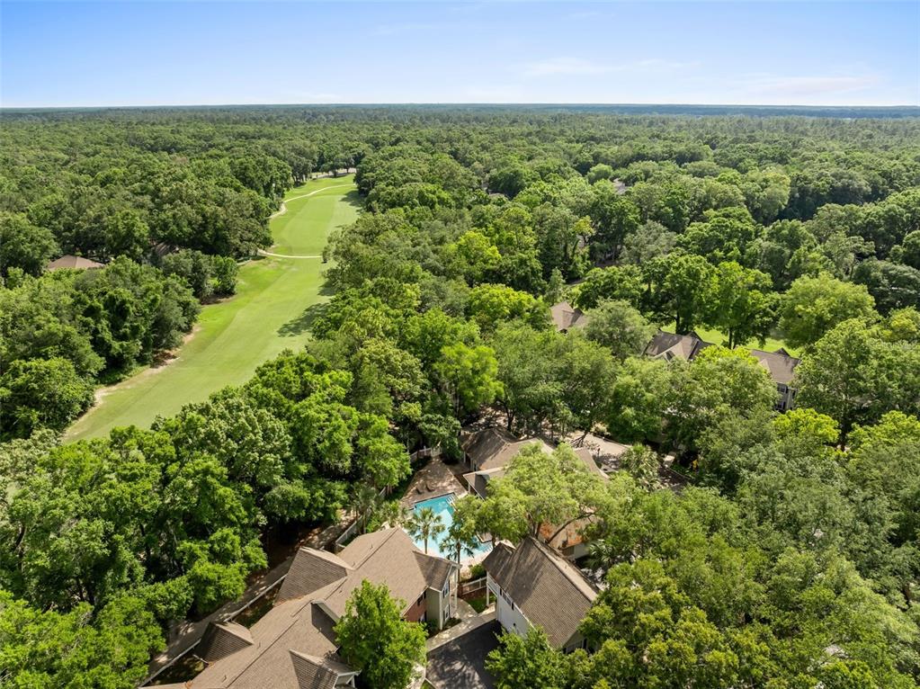 10000 Southwest 52nd Avenue, Unit 35 Gainesville, FL 32608 - Photo 31 of 36 an aerial view of residential houses with outdoor space and trees