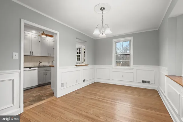 a view of empty room with wooden floor and stove