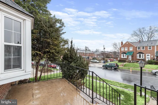 a view of a street with sitting area and fence