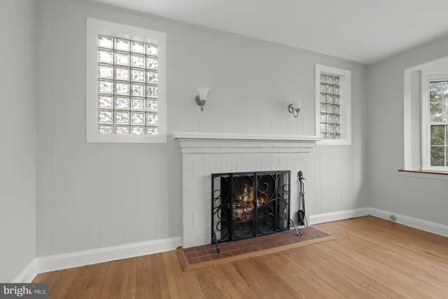 a view of an empty room with a fireplace and a window