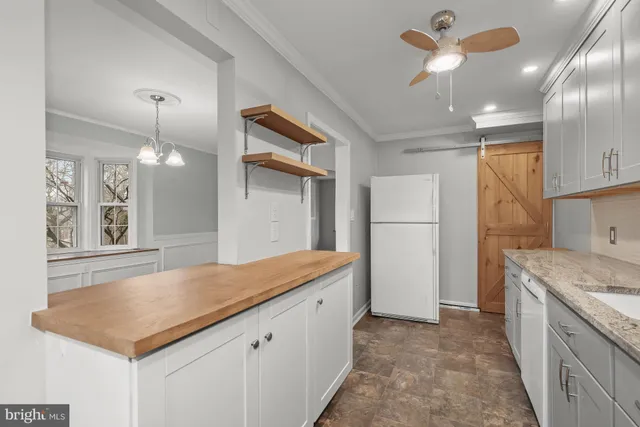 a kitchen with stainless steel appliances granite countertop a sink a refrigerator and a stove