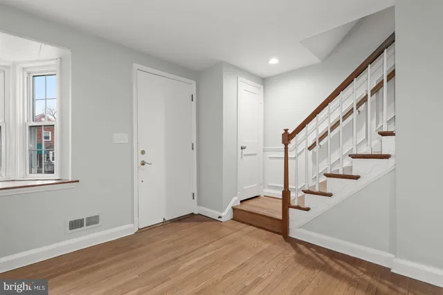 a view of an entryway with wooden floor and stairs