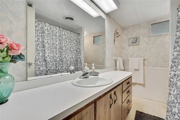 a bathroom with a sink a bath tub and a shower