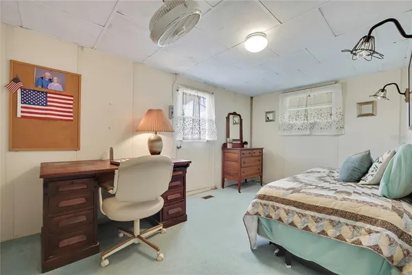 a bedroom with a bed a desk and chair