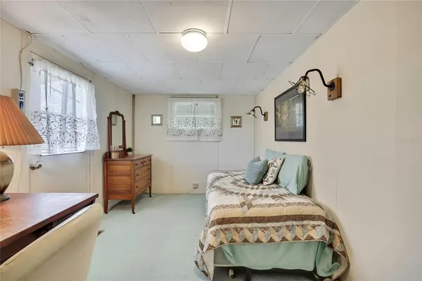 a bedroom with bed and window