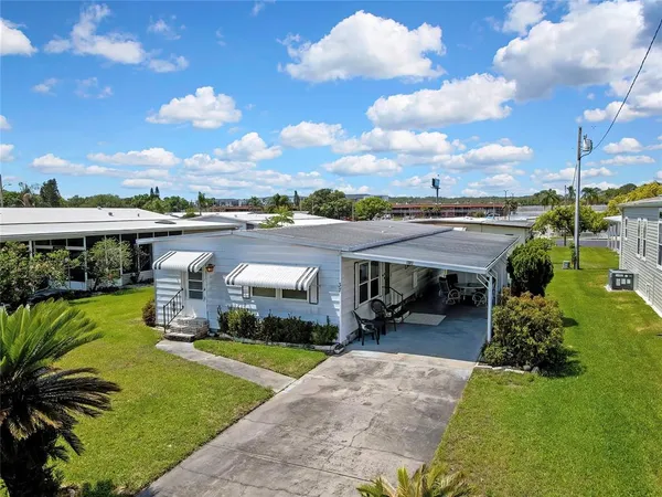 a view of a house with a backyard porch and sitting area