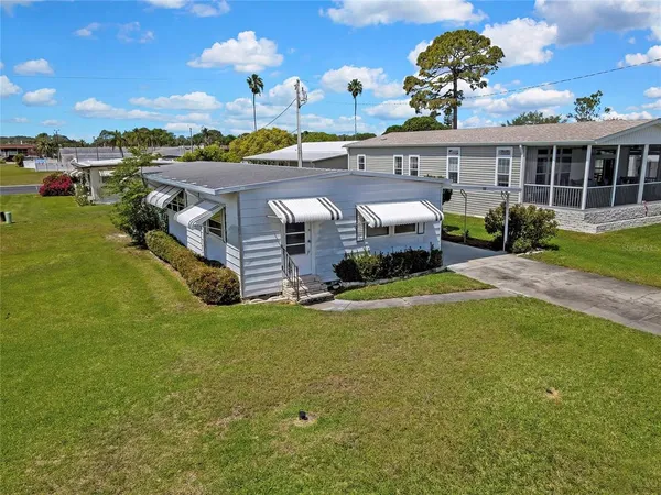 an aerial view of residential houses with outdoor space and parking