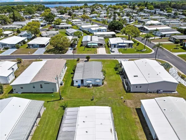 an aerial view of a swimming pool with lawn chairs