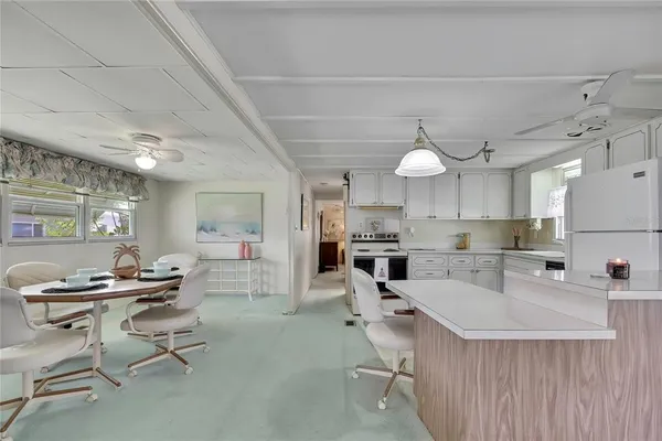 a room with stainless steel appliances kitchen island granite countertop furniture and a view of kitchen