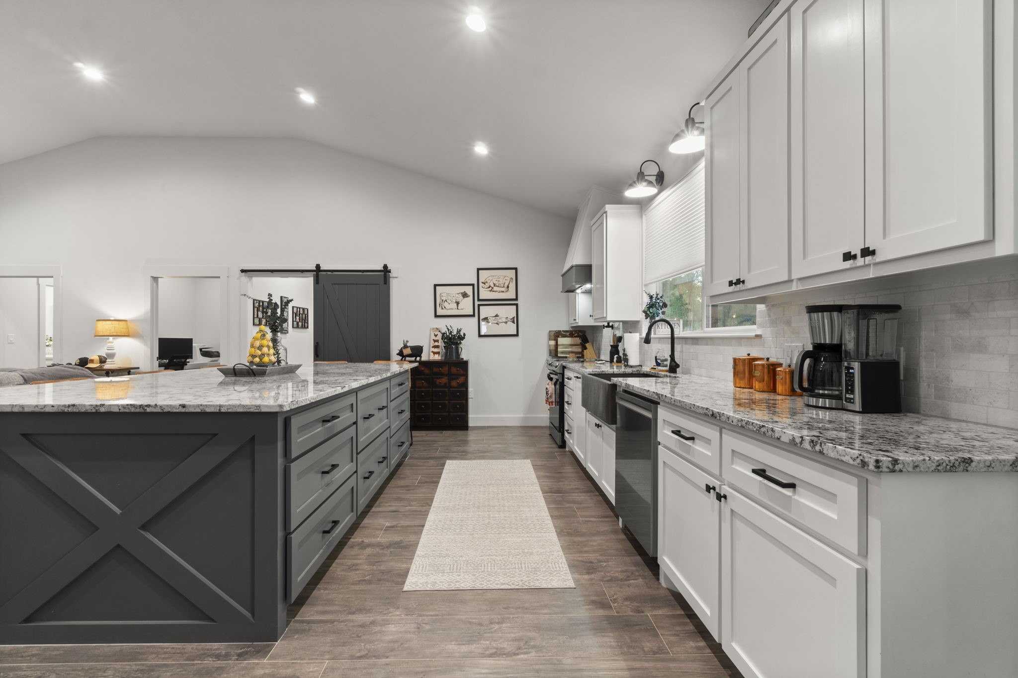 15651 Ben Wiggins Road Conroe, TX 77303 - Photo 13 of 47 a large kitchen with stainless steel appliances kitchen island granite countertop a large counter top and a stove top oven