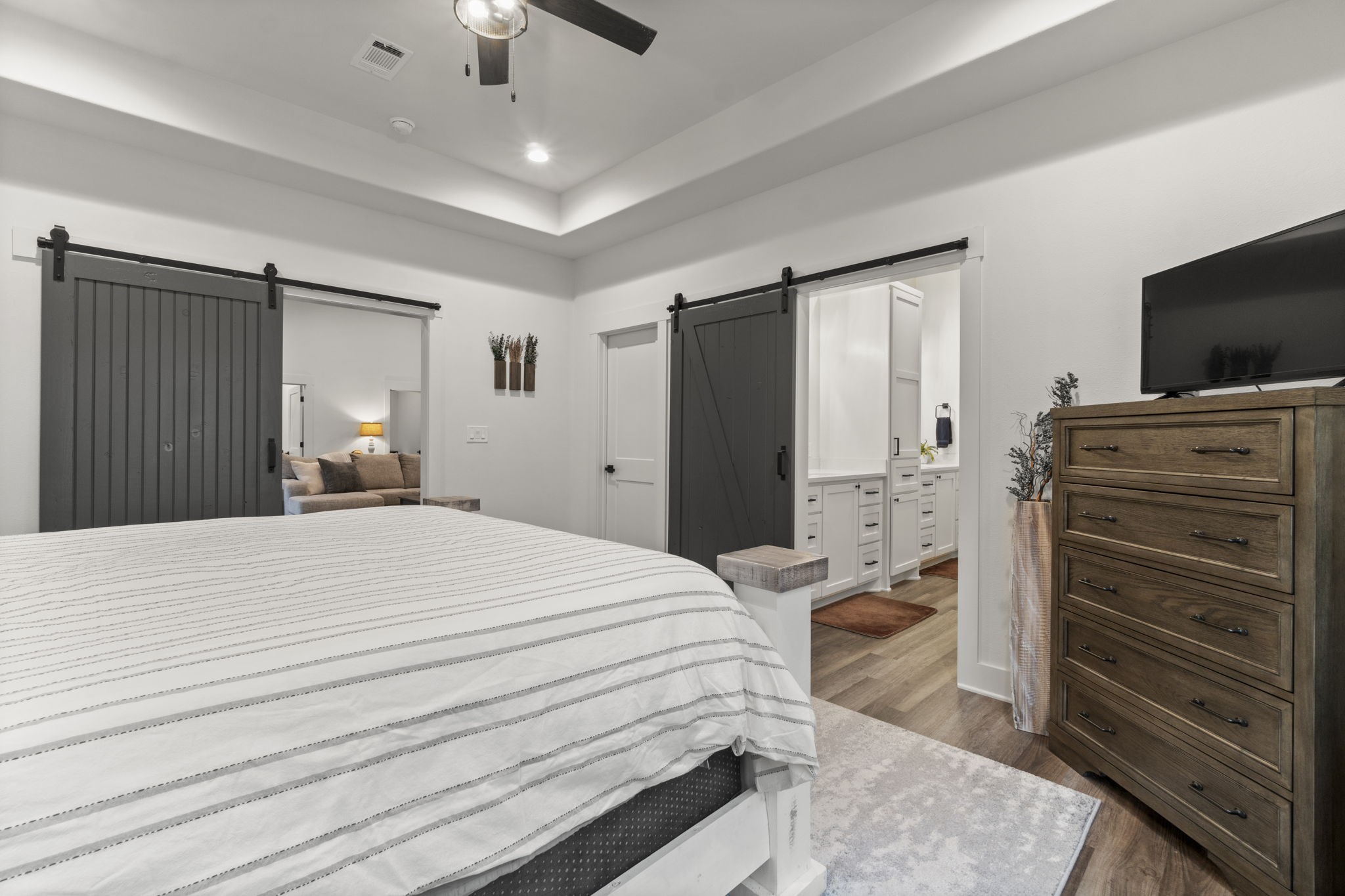 15651 Ben Wiggins Road Conroe, TX 77303 - Photo 20 of 47 a bedroom with a bed and a flat tv screen on dresser