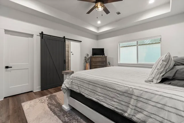 a bedroom with a bed and a window