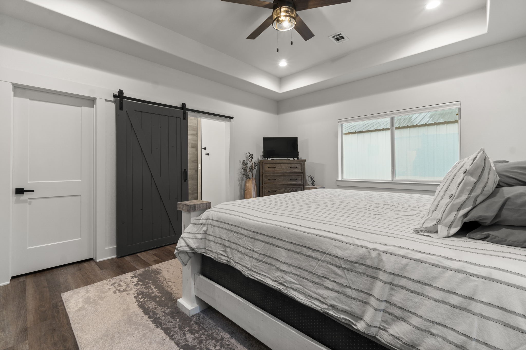 15651 Ben Wiggins Road Conroe, TX 77303 - Photo 21 of 47 a bedroom with a bed and a window