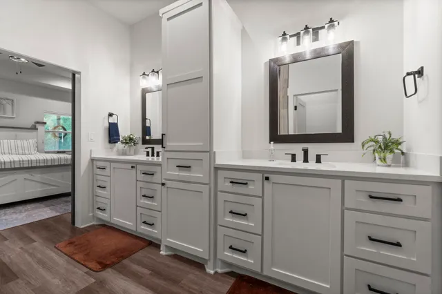 a bathroom with a double vanity sink mirror and
