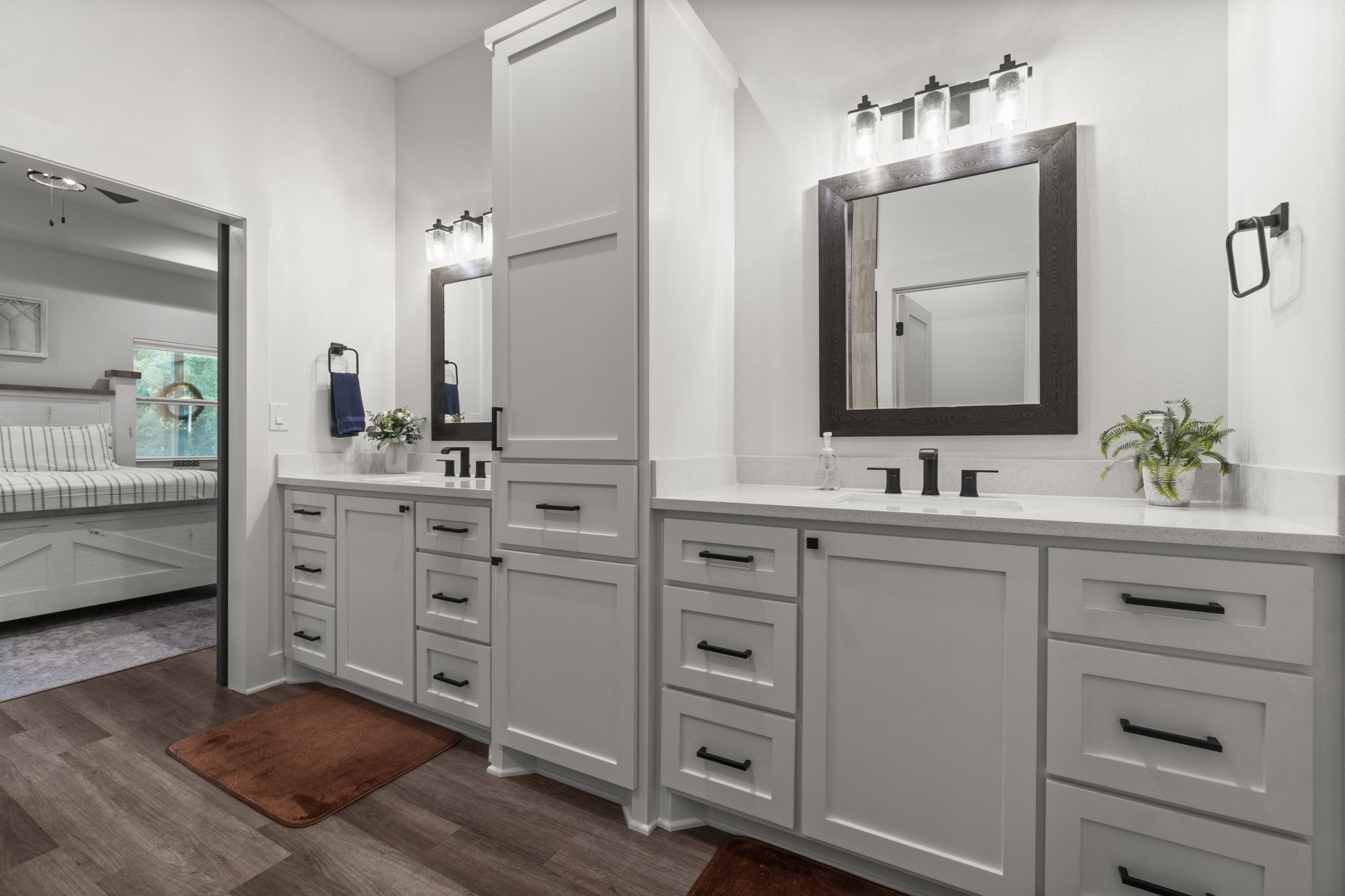 15651 Ben Wiggins Road Conroe, TX 77303 - Photo 23 of 47 a bathroom with a double vanity sink mirror and