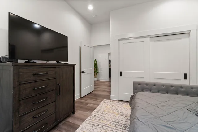 a bedroom with a bed and a flat screen tv