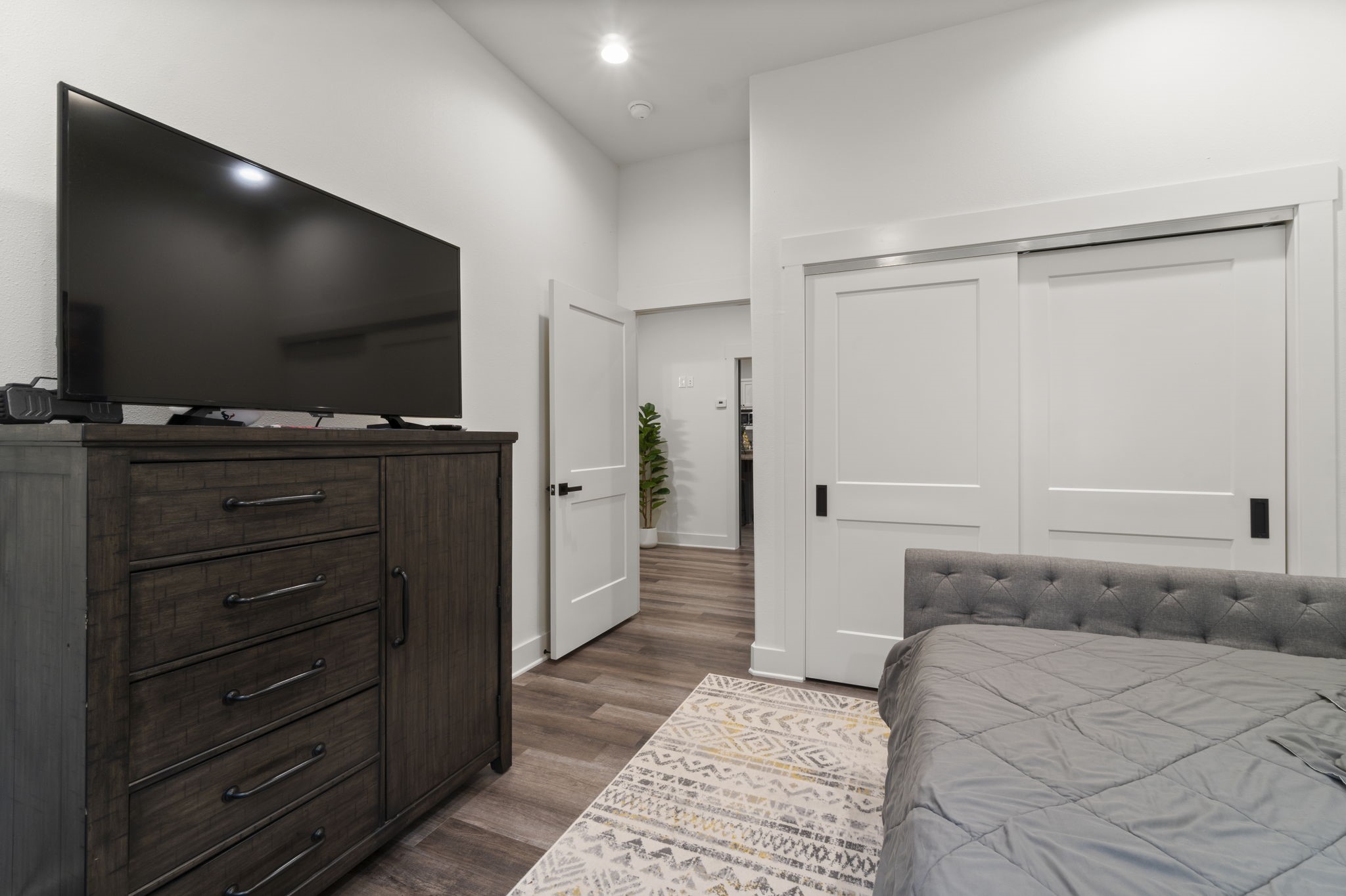 15651 Ben Wiggins Road Conroe, TX 77303 - Photo 27 of 47 a bedroom with a bed and a flat screen tv