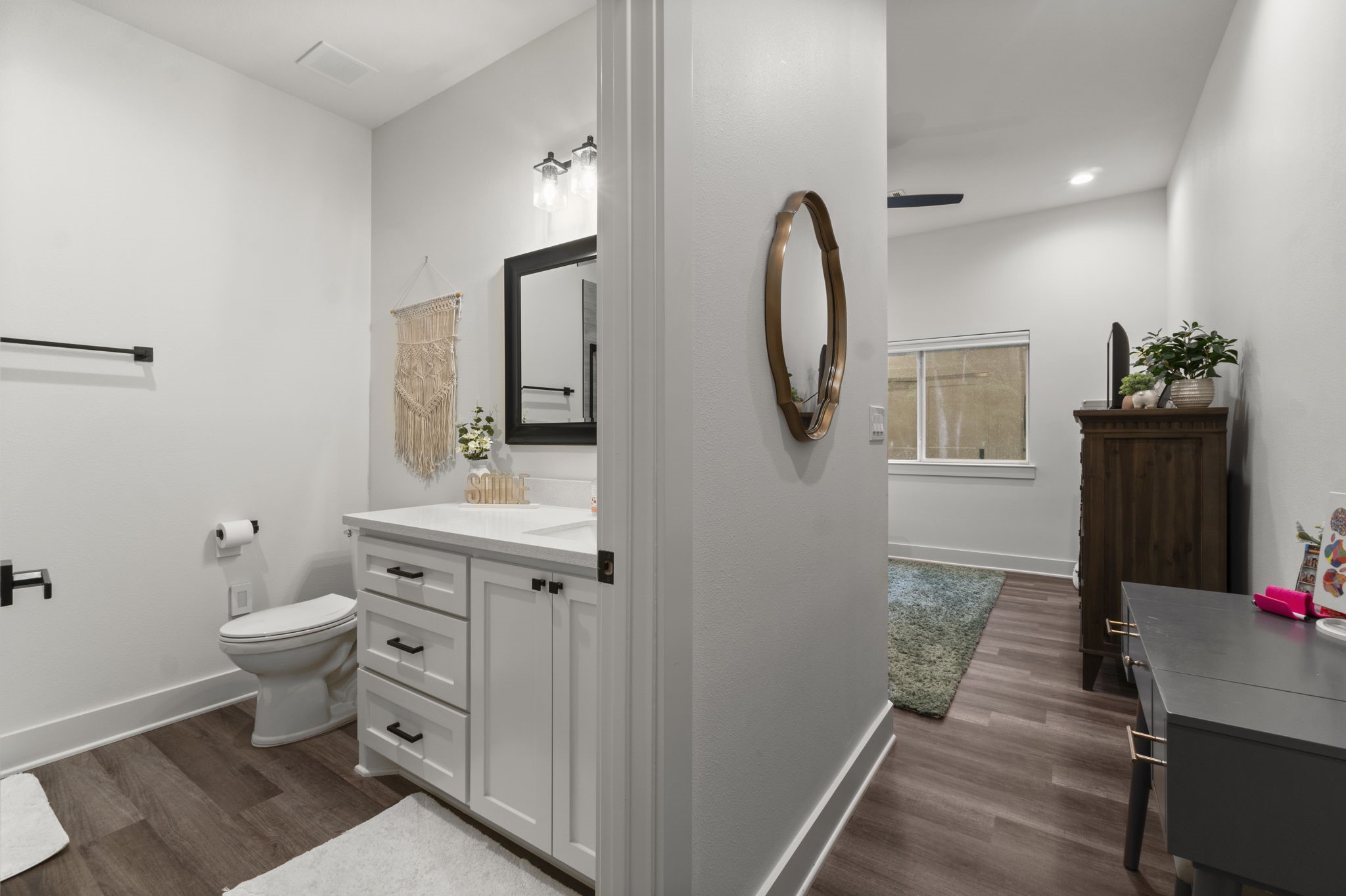 15651 Ben Wiggins Road Conroe, TX 77303 - Photo 28 of 47 a spacious bathroom with a toilet a sink and mirror