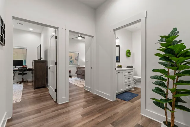 a view of a hallway view with wooden floor and a potted plant