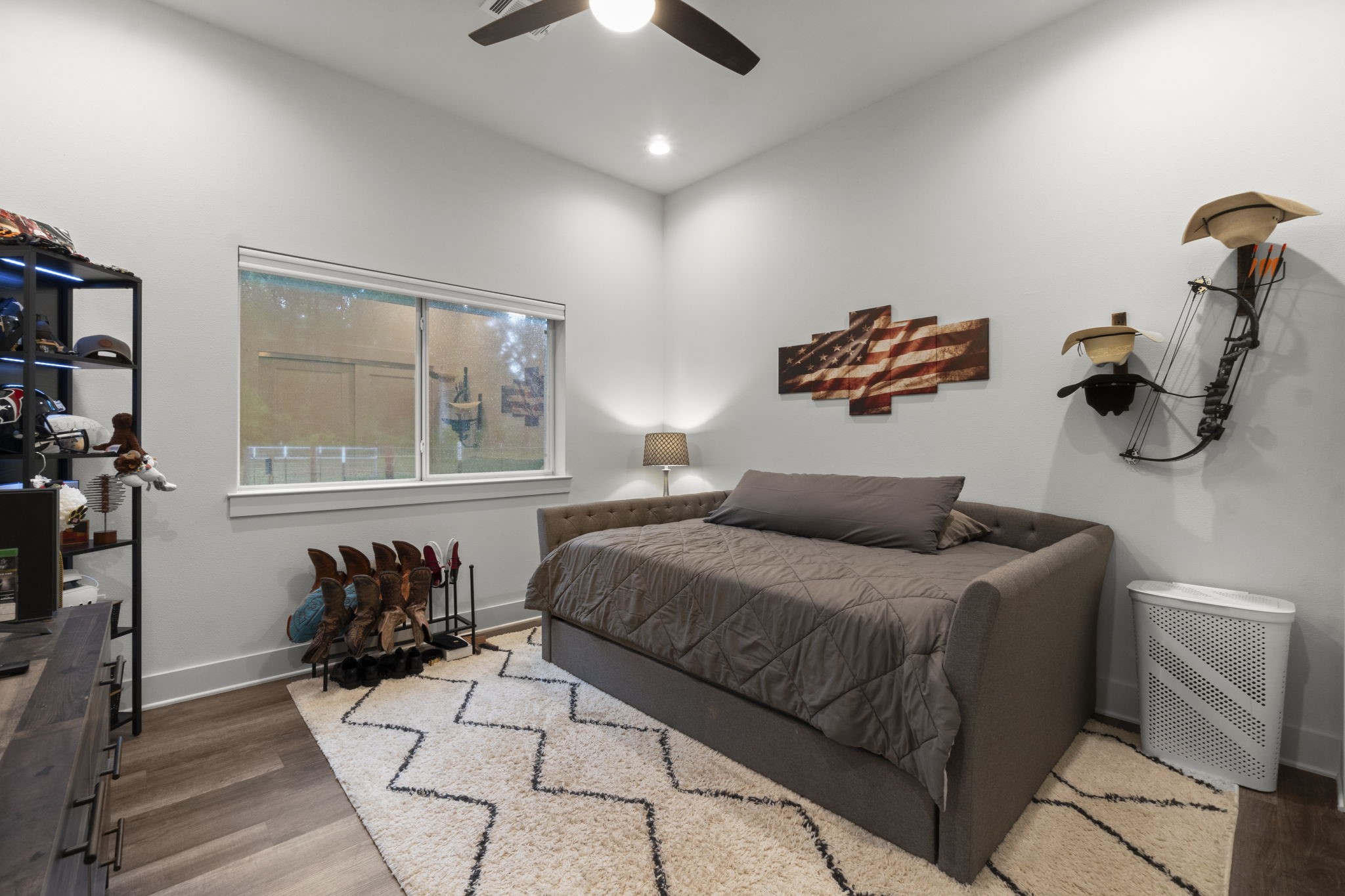 15651 Ben Wiggins Road Conroe, TX 77303 - Photo 32 of 47 a bedroom with a bed and wooden floor