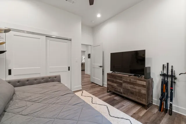 a bedroom with furniture and flat screen tv