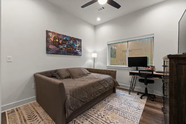 a bedroom with bed and a flat screen tv