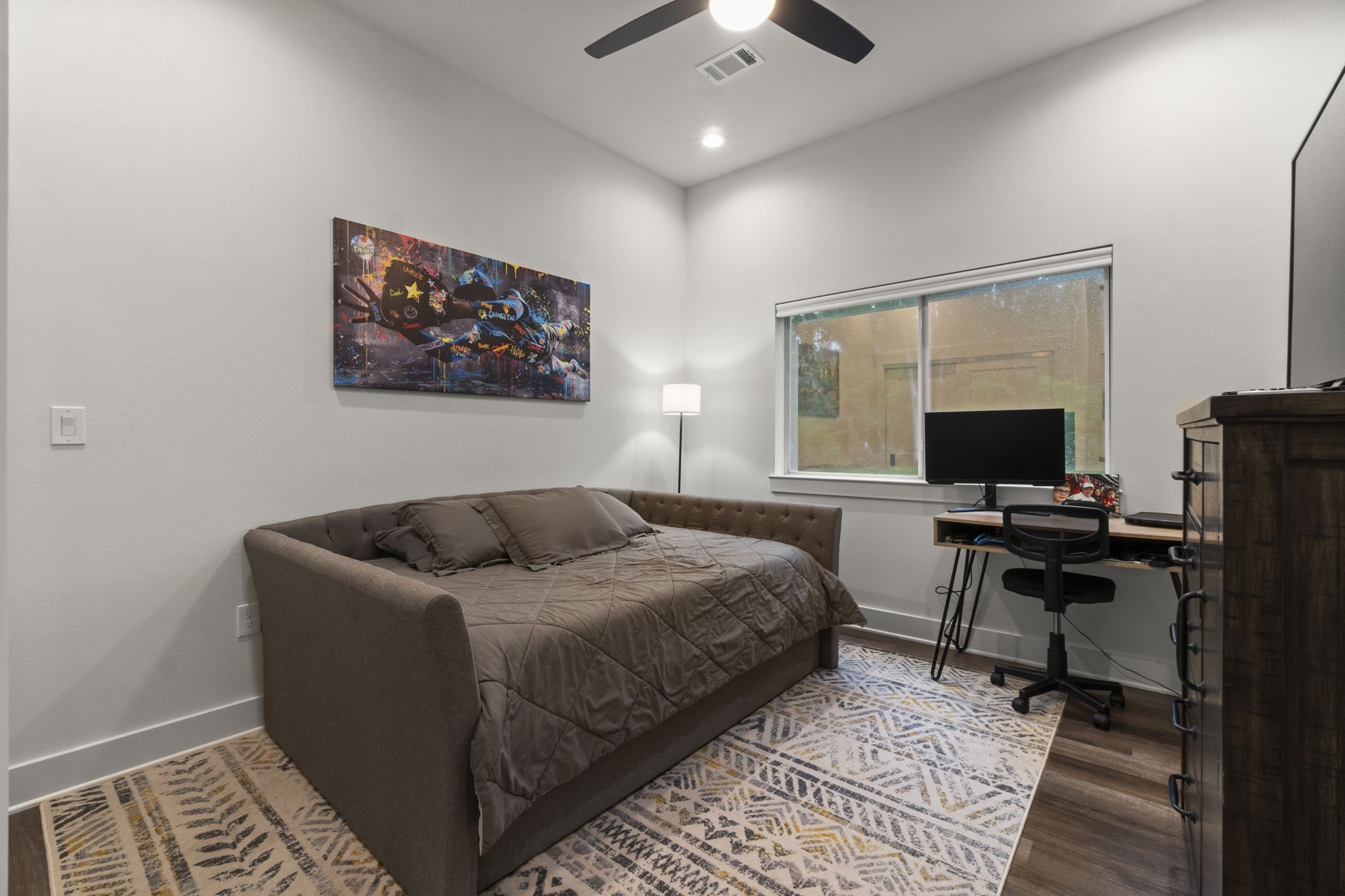 15651 Ben Wiggins Road Conroe, TX 77303 - Photo 34 of 47 a bedroom with bed and a flat screen tv