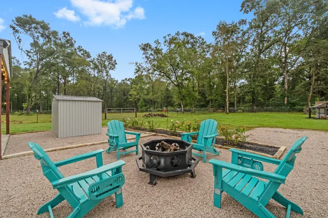 a view of a backyard with sitting area