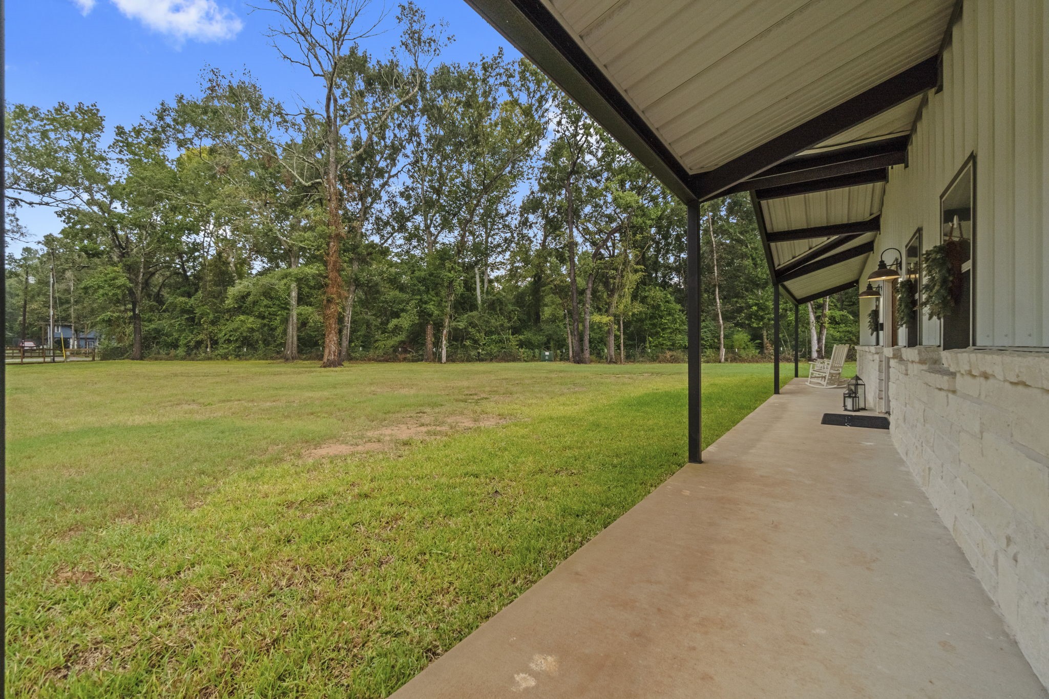 15651 Ben Wiggins Road Conroe, TX 77303 - Photo 41 of 47 a view of a house with a big yard and large trees