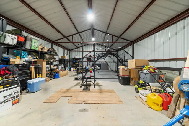 a view of a grassy field with trees in the background