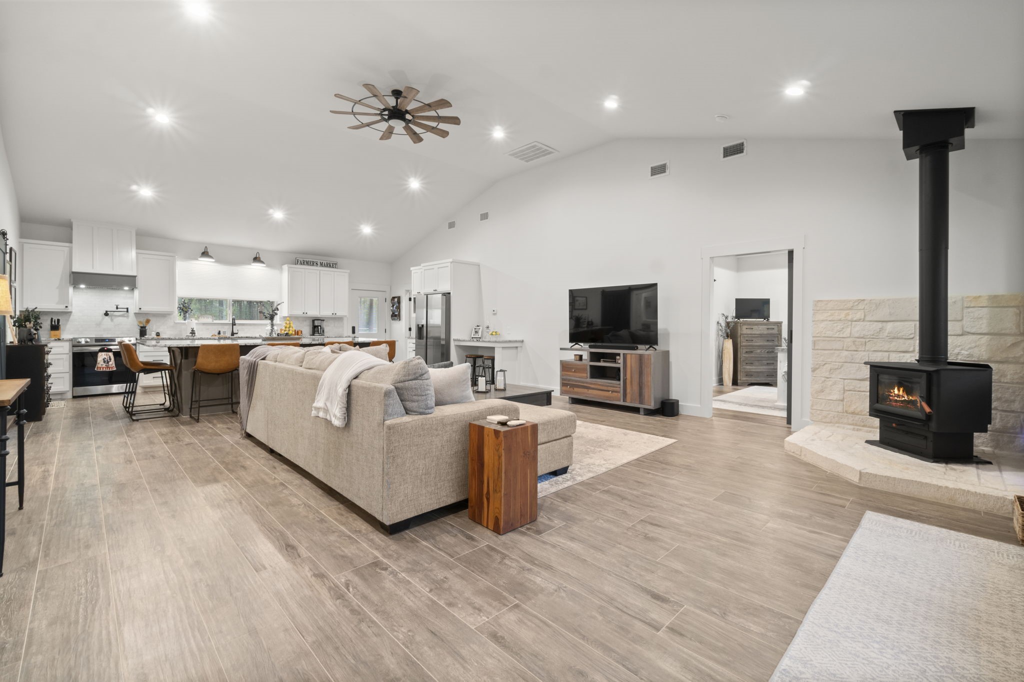 15651 Ben Wiggins Road Conroe, TX 77303 - Photo 5 of 47 a living room with furniture kitchen area and a flat screen tv